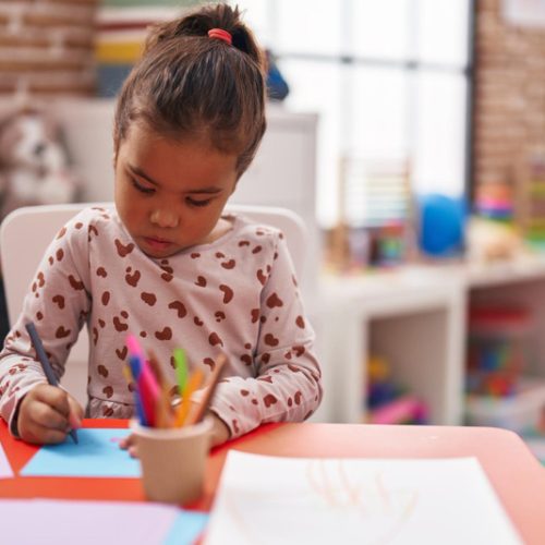 adorable-hispanic-girl-student-sitting-table-drawing-paper-kindergarten-1-Copy.jpg